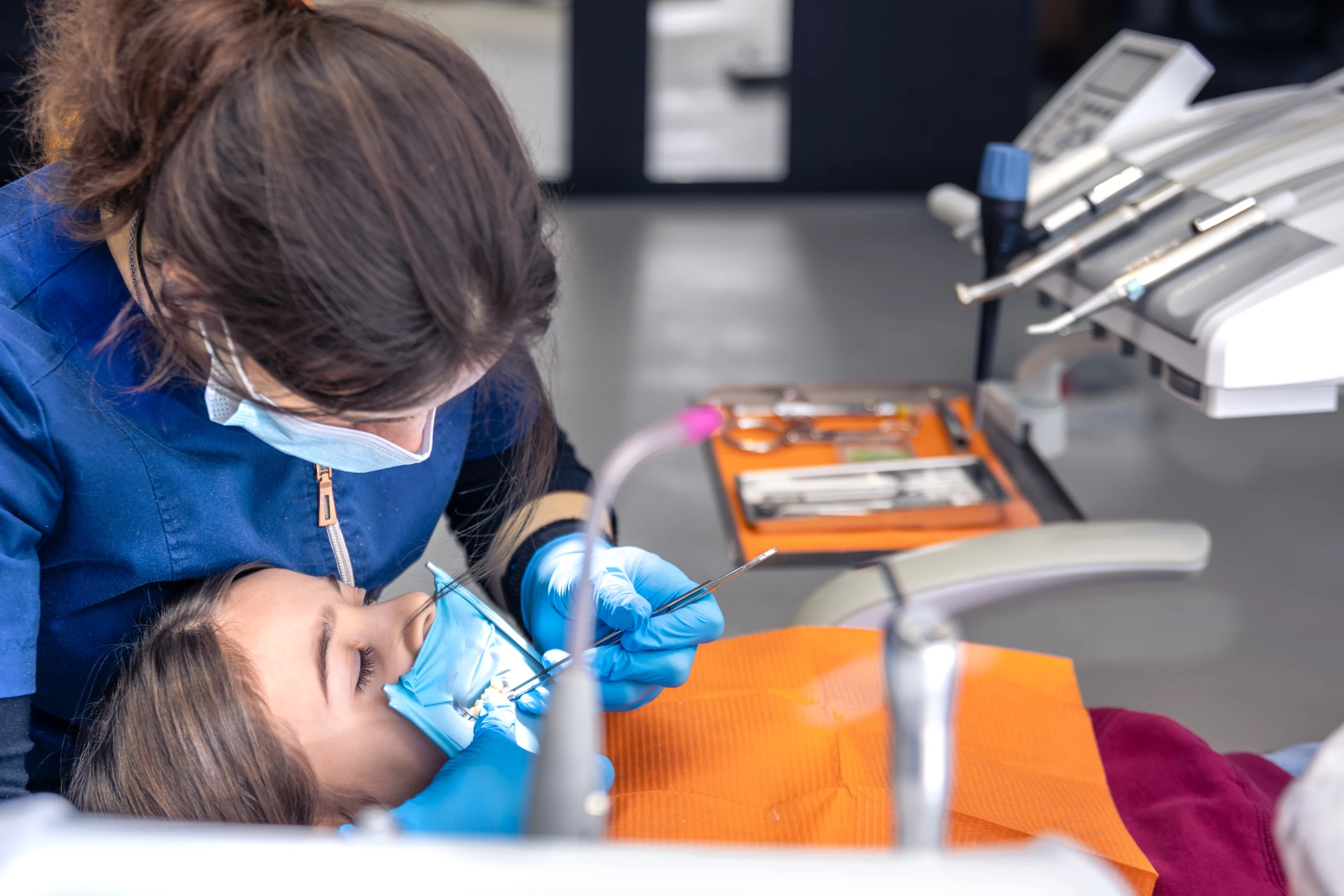 Pediatric dentist providing gentle dental care to a child during a dental visit near Merrifield, VA